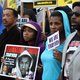Demonstrators stand for justice for Trayvon Martin. (David McNew/Getty Images)